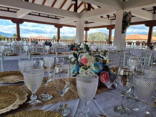 a table set up for a wedding with wine glasses at Hotel Gran Sirius in Sáchica