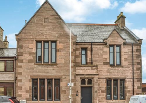 an old brick house with a roof at 'The Kepties' Luxurious Serviced Apartments in Arbroath