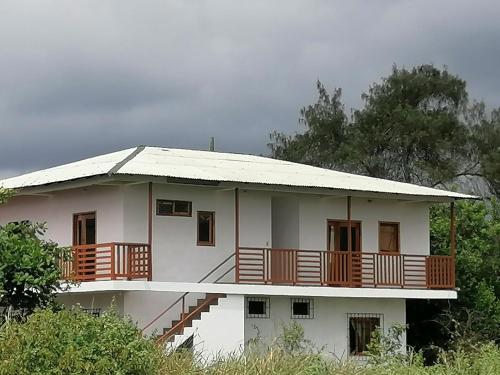 a large white house with a large balcony at WIPEOUT SUIT in Puerto López