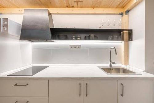 a kitchen with a sink and a stove at CASA ALTA LOFT in Málaga