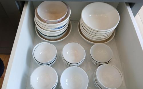 a drawer filled with white plates and bowls at TerraCotta Beachfront Villa Phan Thiet in Phan Thiet