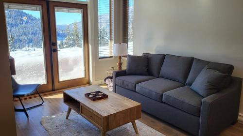 a living room with a couch and a coffee table at Powder Heights #22 townhouse in Sun Peaks