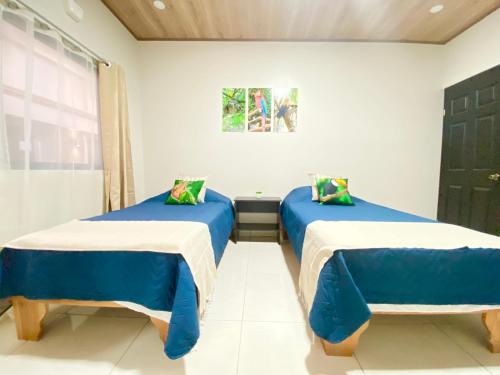 two beds in a room with blue and white at Apartamentos H Gonzalez. Wifi A/C free parking in San Rafael