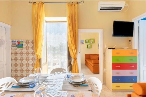 a dining room with a table and chairs at LA CALETTA HOME in Villanova di Ostuni