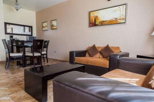 a living room with a couch and a table at Hotel Real de San Jose in Tequisquiapan