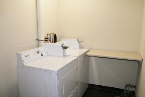 a white laundry room with two white boxes on a counter at WYE Motor Lodge Duncansville - Altoona in Duncansville