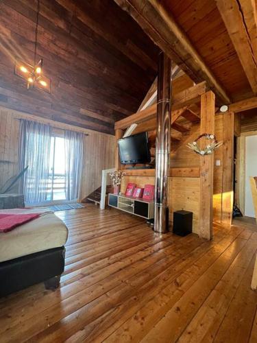 1 dormitorio con 1 cama y TV de pantalla plana en Chalet Le Verdier, en Champlain