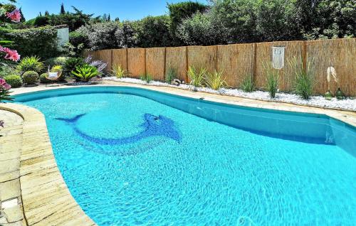 a large blue swimming pool in a backyard at La Maison De Nelly in Paradou