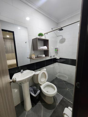 a bathroom with a toilet and a sink at HOTEL CASA MARED Corferias-Embajada Americana in Bogotá