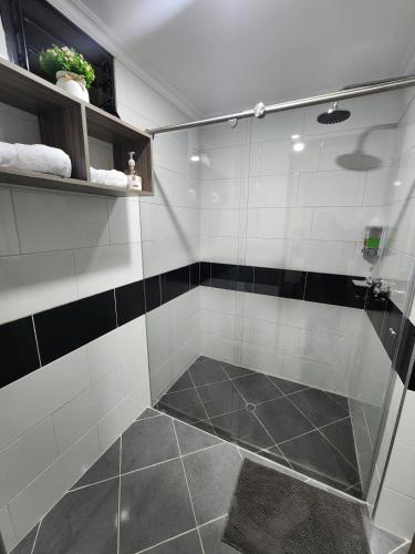 a shower with a glass door in a bathroom at HOTEL CASA MARED Corferias-Embajada Americana in Bogotá