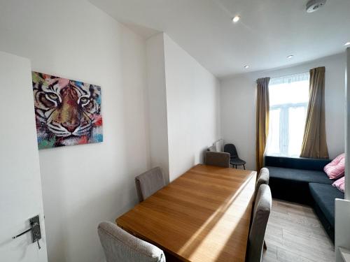 a living room with a table and a couch at Flat B, Stay In Earlsfield in London