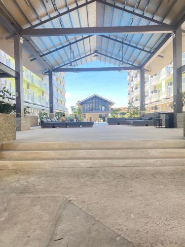 an empty parking lot with a building in the background at Travelers Delight Amani Grand Resort Residences 3-5mins from airport in Mactan