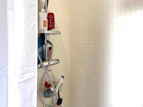 a towel rack in a bathroom with a shower curtain at Holiday home HÄLLEKIS in Lugnås