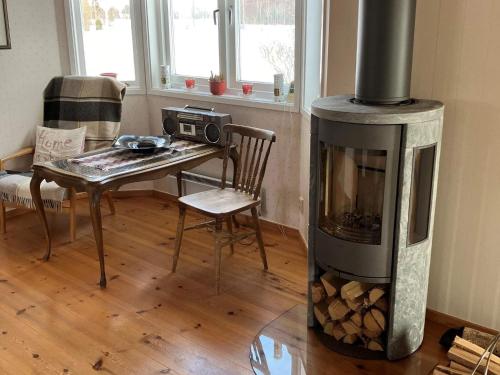 a living room with a fireplace and a table at 6 person holiday home in SUNNE-By Traum in Sunne
