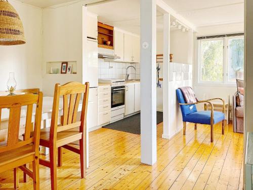 a kitchen and dining room with a table and chairs at 4 person holiday home in HERRäNG-By Traum in Herräng