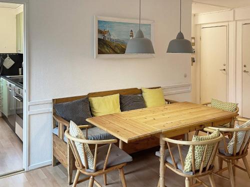 a living room with a wooden table and a couch at 4 star holiday home in Olofström-By Traum in Olofström