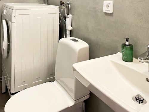 a bathroom with a white toilet and a sink at 4 star holiday home in Olofström-By Traum in Olofström