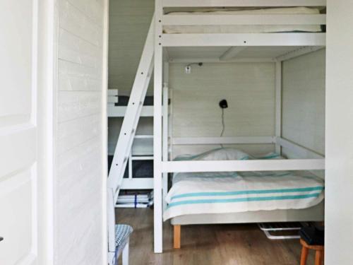 a bunk bed with a ladder in a room at 6 person holiday home in MELLBYSTRAND-By Traum in Mellbystrand