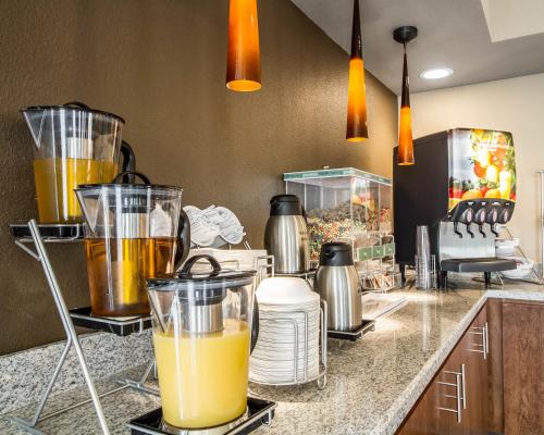 a kitchen with a counter with some orange juice at Comfort Suites Woodland - Sacramento Airport in Woodland