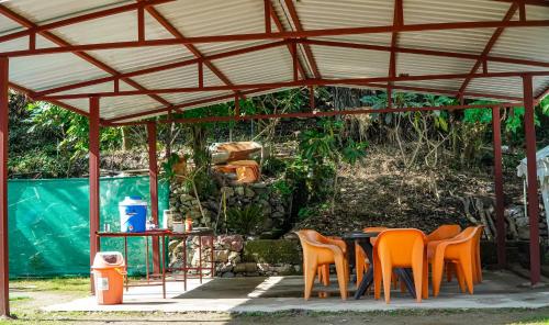 une table et des chaises installées sous un pavillon dans l'établissement The FnF Resort & Camping - Rishikehs, à Rishikesh