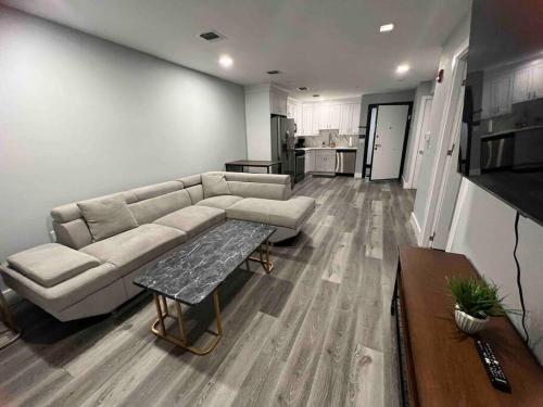 a living room with a couch and a table at The Lovely Suite - 1BR close to NYC in Paterson