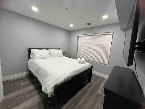 a bedroom with a bed with a stuffed animal on it at The Lovely Suite - 1BR close to NYC in Paterson