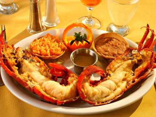 a plate of food with shrimp and other foods on a table at Las Rocas Resort & Spa in Rosarito