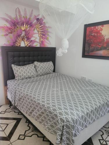 a bedroom with a bed with a gray comforter at Exquisite Home away from Home! in Kingstown