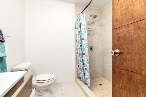 un baño con inodoro y ducha en Bright Chick Condo 19 Gardenhaus, en Tijuana