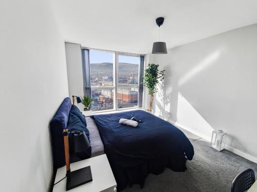 a bedroom with a bed and a large window at Sky High Ensuite Bedroom in Shared Apartment in Belfast City Centre in Belfast