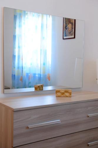 a mirror on top of a dresser in a room at Le Residenze Salentine - Case Vacanza in Lecce in Lecce