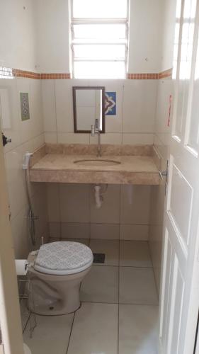 a bathroom with a sink and a toilet at Casa Patrimônio Histórico - Centro de Uberaba in Uberaba