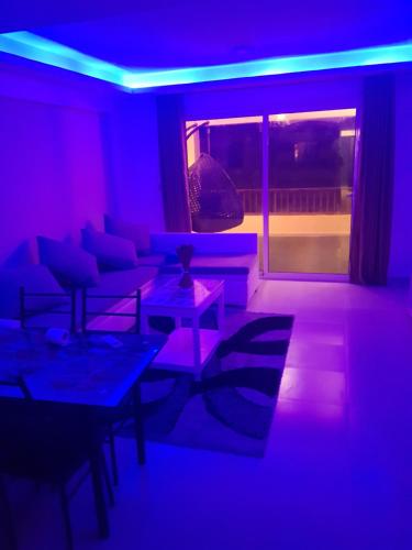 a living room with a blue and purple lighting at Holiday Dream port Ghalib in Abu Dabab