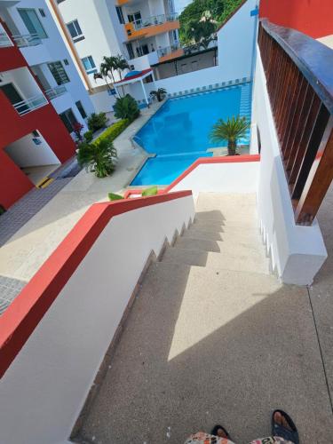a view of a swimming pool from the balcony of a building at Tonsupa Beach in Tonsupa
