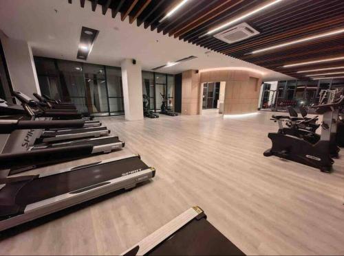 a gym with treadmills and elliptical machines at K Avenue Cozy Family Suites 4-6 pax 亚庇国际机场5分钟 in Donggongon