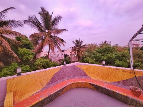 a view of a bridge with palm trees in the background at Park Breeze Penthouse in Bangalore