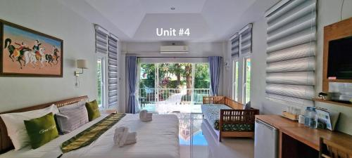 a bedroom with a bed and a living room at Chang Noi Hua Hin Pranburi fully accessible barrierefrei resort in Ban Nong Sua
