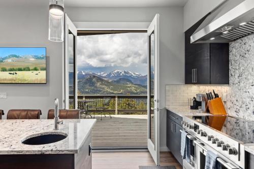 a kitchen with a view of the mountains at Casa de Cristal-Epic Views-HotTub-Sauna-Sleeps 10-Luxury Linens-Stocked Kitchen in Estes Park