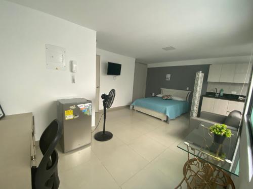 a room with a bed and a room with a refrigerator at Apartamento en envigado in Envigado