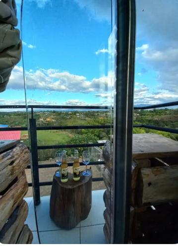 a table with wine glasses on a balcony with a view at Vibras Eco Hotel in Popayan
