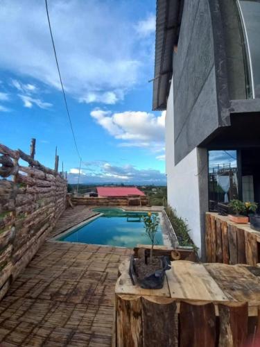 a house with a swimming pool and a fence at Vibras Eco Hotel in Popayan