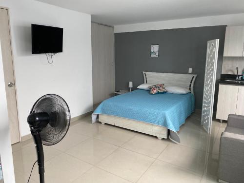 a bedroom with a bed and a fan in it at Apartamento en envigado in Envigado