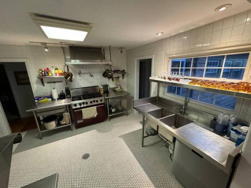a kitchen with a sink and a stove in it at Serene Stay - Stylish House Close to NYC in Paterson