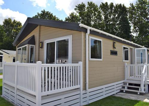 a tiny house with a white picket fence at Hamlet Rise in Leven