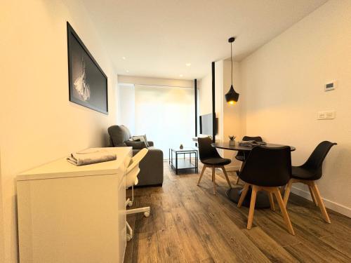 a living room with a table and chairs at Apartamentos Identia Sport by gaiarooms in León