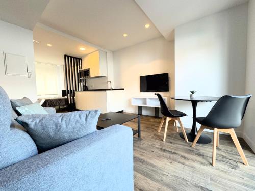 a living room with a couch and a table at Apartamentos Identia Sport by gaiarooms in León