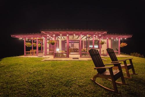 two chairs in front of a gazebo at night at La Casa en las Nubes in Salento
