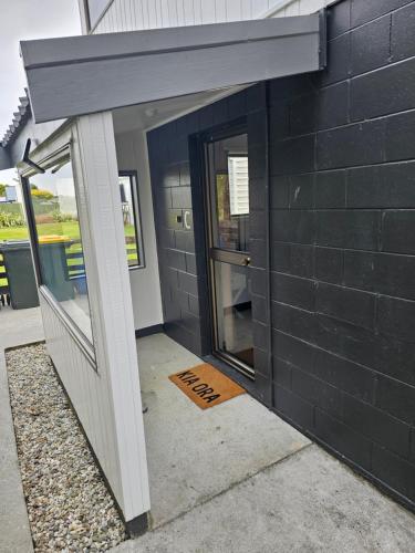 an entrance to a building with the door open at Catlins area accommodation in Owaka