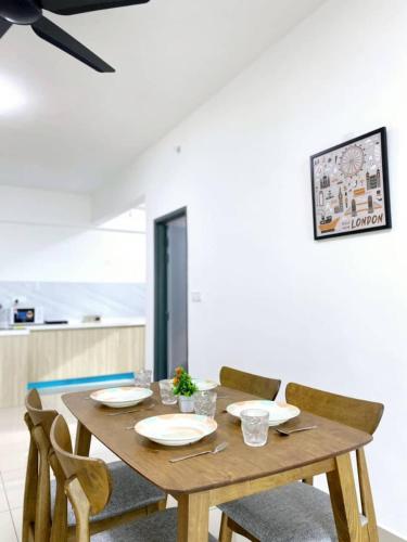 a wooden table with chairs and a dining room at JOVIAL Modern Cozy Suite `Metropol BM BandarPerda in Bukit Mertajam