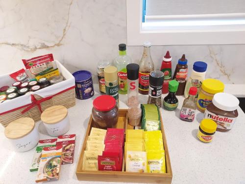a counter topped with lots of different types of food at Luxury 5 Bedroom Home - Sentinel Chalet - Snowy Mountains - Jindabyne in Jindabyne